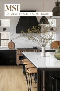 a kitchen with black cabinets and white counter tops