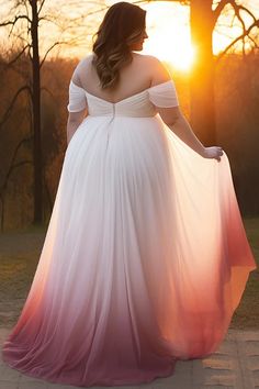 a woman in a white and pink dress is walking towards the sun with her hands on her hips