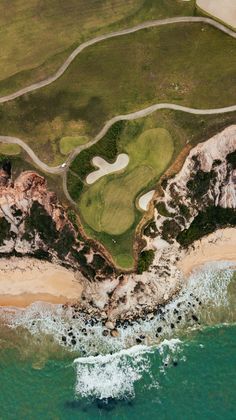 an aerial view of a golf course near the ocean