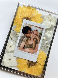 an image of a couple kissing in front of sunflowers on a white background