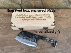 a wooden box with a knife inside and an engraved message on the lid next to it