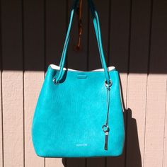 Brand New 13" H X 14" W X 6" D Beautiful Turquoise Bag, Comes With Dust Cover. 29 " Double Handles. Blue Bucket Satchel With Detachable Handle, Calvin Klein Shoulder Bag For Everyday, Blue Hobo Bag With Detachable Handle For Shopping, Blue Double Handle Bucket Bag For Errands, Blue Bucket Bag With Detachable Handle For Errands, Modern Turquoise Bag For Everyday Use, Calvin Klein Rectangular Bags With Silver-tone Hardware, Turquoise Bags With Detachable Strap For Daily Use, Turquoise Bag With Detachable Strap For Everyday Use