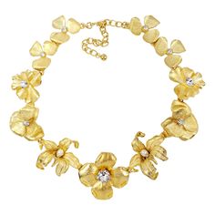 Glowing feminine beauty! This satin gold flower collar necklace with crystal and white faux pearl centers elevates any look with sparkling, blooming flowers cast in a golden gleam. Length 14.5 in / 37 cm plus 3.25 in / 8.5 cm extension Necklaces Flower, Gold Flower Necklace, Flower Collar, Multi Strand Beaded Necklace, Elephant Pendant Necklace, Flower Statement Necklace, Hook Necklace, Jewelry Flower, Necklace Flower