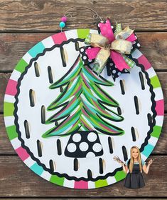 a paper plate with a christmas tree on it next to a cutout of a woman