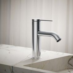 a chrome faucet sitting on top of a white countertop next to a sink