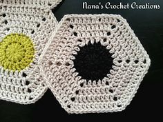 two crocheted coasters with black and yellow circles on them, one is white and the other is green