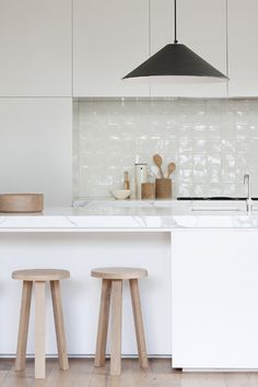 three stools are in front of the counter