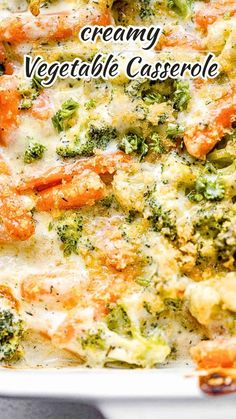 a casserole dish with broccoli, cheese and carrots in it