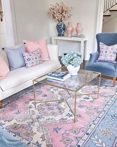 a living room filled with blue and pink furniture