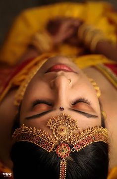 a woman with her eyes closed laying down