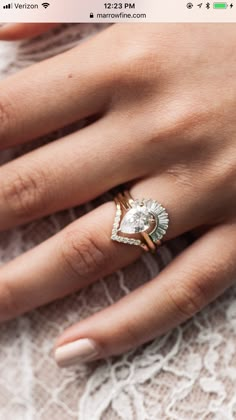 a close up of a person's hand with a ring on it