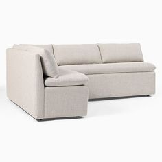 a white couch and ottoman sitting next to each other