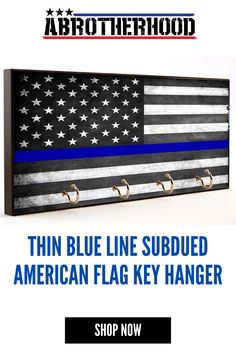 the thin blue line flag key hanger is on display in front of an american flag