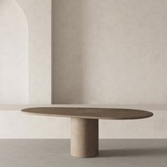 an oval table in the middle of a room with white walls and arches around it