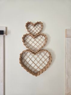 two heart shaped baskets hanging on the wall