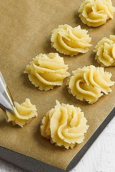 some kind of food that is sitting on a cutting board with a knife in it