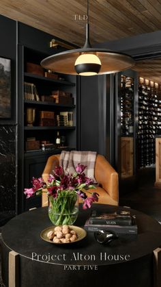 a living room filled with furniture and a table topped with a vase of flowers next to a fire place