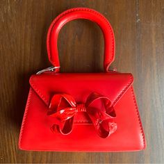 From Self-Portrait, Mini Top Handle Bag In Smooth Red Leather With Metal Bow Detail. Includes Shoulder Strap, Dust Bag, And Box. New And Never Used. H: 3.5” (7” With Handle) L: 5.5” At Base W: 2” At Base Luxury Red Evening Bag With Removable Pouch, Luxury Red Evening Bag With Detachable Handle, Red Clutch Evening Bag With Detachable Handle, Luxury Red Satchel Evening Bag, Chic Red Clutch Bag, Red Evening Clutch With Detachable Handle, Designer Red Shoulder Bag, Elegant Red Evening Bag For Shopping, Red Shoulder Bag With Detachable Handle For Evening