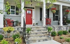 a red door sits on the front steps of a white house