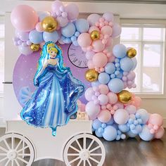 there is a balloon arch with a princess on it and balloons all over the place