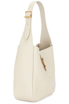 Find SAINT LAURENT Supple Hobo Bag In Ivory on Editorialist. Saint Laurent Supple Hobo Bag in Ivory Grained leather with suede lining. Made in Italy. Open top with interlaced YSL hook closure. One main compartment with single slip and zip pockets. Adjustable shoulder strap. Measures approx 8.5W x 8.5H x 3.75D Shoulder strap with a 9 drop. SLAU-WY2778. 713938-AAAUQ-9207. About the designer: SAINT LAURENT has been influencing and revolutionizing the fashion industry since the debut of its iconic ‘Rive Gauche’ collection in 1966 - the couture house was the first to create a ready-to-wear capsule. The sleek, precisely tailored staples, like the signature biker jackets, transcend seasons and trends. Creative Director Anthony Vaccarello continues to honor the label’s illustrious reputation by re Designer Bucket Hobo Bag With Gold-tone Hardware, Designer Bucket Shoulder Bag With Leather Lining, Designer Textured Leather Tote Bucket Bag, Luxury Textured Leather Bucket Shoulder Bag, Luxury Textured Leather Shoulder Bucket Bag, Designer Shoulder Bag With Gold-tone Hardware For Everyday Use, Designer Everyday Shoulder Bag With Gold-tone Hardware, Luxury Textured Leather Hobo Tote Bag, Luxury Textured Leather Bucket Bag