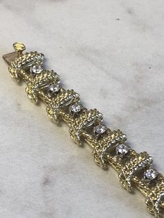 "18kt Yellow Gold Heavy Solid Lady's Cubic Zirconia (CZ) Bracelet 7\" in Length. This Bracelet consists of 18- 3mm, .10ct each , 1.80ctw Cubic Zirconia (CZ) all prong set in 14kt White Gold settings in a heavy solid 12mm wide hinged mounting. There is a hidden box clasp with a secure fig 8 safety clasp. These CZ's look so real. Total mounting weigh is 43.8 grams. This item would Retail for $6,550.00" Gold Cubic Zirconia Tennis Bracelet Hand Set, Fine Jewelry Diamond Bracelet With Sparkling Stones For Anniversary, Luxury Diamond Gold Bracelet With Sparkling Stones, Luxury Gold Diamond Bracelet With Sparkling Stones, Gold Bracelet With Single Cut Diamonds For Anniversary, Gold Tennis Bracelet With Single Cut Diamonds For Wedding, Luxury Yellow Gold Bracelet With Sparkling Stones, Diamond Bracelets In Yellow Gold With Sparkling Stones, Diamond Gold Bracelet With Sparkling Stones