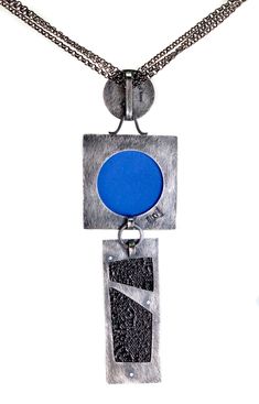 One of a kind textural necklace comprised of three vitreous enamel sections, one with fine silver grid set in sterling silver, the next a highly textured abstract also set in sterling, the last a layered enamel on waffled copper on sterling, all with patina, with black steel color chain that adjusts 17 - 20" with sterling hook clasp, enamel elements measure 5.25" long. Contemporary Blue Jewelry For Gifts, Modern Silver Enamel Jewelry, Modernist Enamel Jewelry For Gifts, Modernist Enamel Jewelry Gift, Contemporary Oxidized Jewelry For Gift, Contemporary Jewelry With Unique Design For Gift, Modern Silver Enamel Necklace, Contemporary Oxidized Finish Jewelry As Gift, Contemporary Oxidized Finish Jewelry For Gift