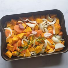 a casserole dish filled with vegetables and onions