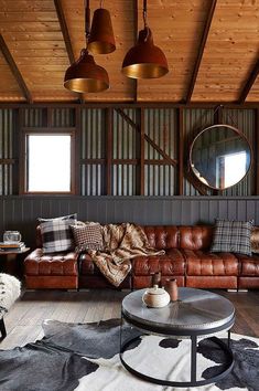 a living room filled with lots of brown furniture