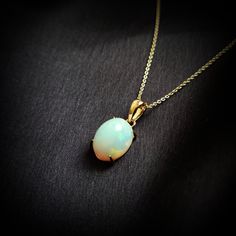 This stunning pendant is set in 14K Solid Yellow Gold with Natural Ethiopion White Opal with utmost precision. It is an unique gemstone pendant for nearly every occasion and is completely hassle-free jewelry. ITEM DETAILS * Gem: White Opal  * Gem Size: 9X12mm * Gem Shape: Oval * Gem Weight: 3.32 carats * Gold Purity: 14KT  * Gold Weight: 0.69 gram * Total Weight of the Pendant: 1.35 gram The Gold purity is guaranteed and it comes with authentic 14KT gold hallmark. Since my items are handmade, they are absolutely nickel and lead free. CUSTOMIZATION * Gemstone customization is available and it can be substituted with a gem of your choice. Kindly message me for the same. PACKAGING * The Pendant comes with layers of safe and secure wrapping along with Free handmade jewelry box with every purch Yellow Gold Ethiopian Opal Round Necklace, Yellow Gold Ethiopian Opal Necklace, Ethiopian Opal Oval Pendant Jewelry Gift, Yellow Gold Ethiopian Opal Necklace For Gift, Oval Ethiopian Opal Necklace For Formal Occasions, Formal Oval Ethiopian Opal Necklace, Formal Ethiopian Opal Oval Necklace, Formal Gold Ethiopian Opal Jewelry, Formal Ethiopian Opal Gold Jewelry