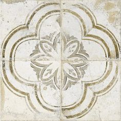 a white and brown tile with an intricate design