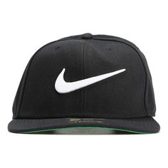 a black hat with white nike logo on the front and green visor around the peak