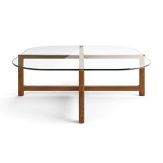 an oval glass table with wooden legs and a white top, on a white background