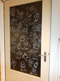 a glass door decorated with halloween doodles