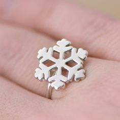 This listing for 1 Sterling Silver Snowflake Ring This solid sterling silver Snowflake is attached to a sterling silver ring. These are cast in our studio, then tumbled and polished to a high shine. We do ship these in a white gift box, so they are perfect for gifts! Each Snowflake is about 3/4 of an inch in length. You can choose your ring size from the drop-down menu. Other snowflake pieces: https://etsy.me/2mFx9qk Take a peek at our other rings - https://etsy.me/2IYWbYB Are you new to Etsy? S Snowflake Ring, Snowflake Jewelry, Christmas Ring, Winter Jewelry, Silver Snowflakes, Jewelry Christmas, White Gift Boxes, Engraved Items, Pretty Jewellery