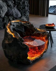 a fire pit sitting on top of a floor next to a table