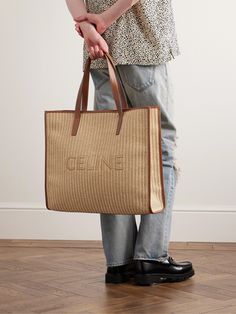 CELINE HOMME's tote is woven from raffia and features the label's moniker across the front. It's reinforced with leather trims and has a generous canvas-lined interior that can easily fit your essentials for a long commute or day at the beach. Luxury Rectangular Straw Bag For Shopping, Luxury Rectangular Straw Shopping Bag, Designer Rectangular Straw Bag In Natural Color, Designer Beige Rectangular Straw Bag, Designer Rectangular Natural Straw Bag, Designer Handwoven Rectangular Straw Bag, Designer Straw Shopping Bag, Designer Rectangular Straw Bag With Braided Handles, Designer Double Handle Straw Bag