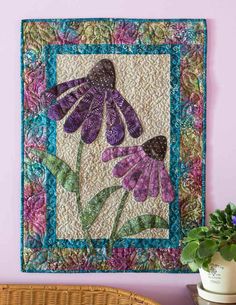 a wall hanging with purple flowers on it