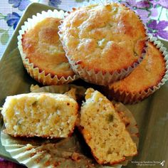 several muffins on a plate with one cut in half