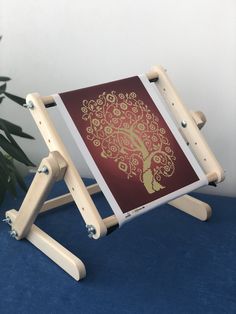 a wooden easel with a red and gold painting on it's back side