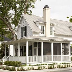 a large white house sitting on the side of a road