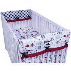 a white crib with a red and black checkered cover