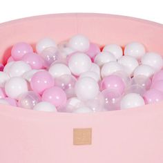 a pink bowl filled with white and pink balls