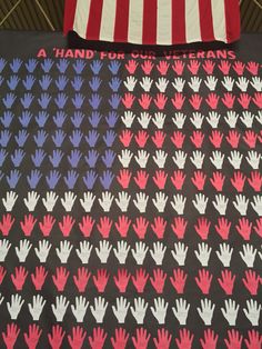 an american flag and hand prints on a black table cloth with red, white, and blue designs