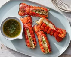 cooked lobsters on a plate with dipping sauce