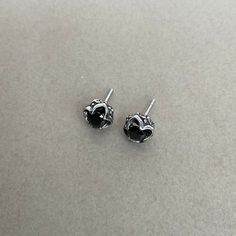 These Gothic studs are crafted with black cubic zirconia stones and made of stainless steel. With a timeless gothic design, these studs are perfect for everyday wear to give your look a subtle edge. Sold as pair Material : 316 Stainless steel Set with Black Cubic Zirconia Size: 9mm Post: 22G / standard piercing Closure: Butterfly push back Ships in a gift box Listing for gothic studs only Black Metal Stud Jewelry, Gothic Silver Jewelry With Studs, Gothic Silver Stud Jewelry, Black Sterling Silver Edgy Earrings, Black Edgy Sterling Silver Earrings, Edgy Black Sterling Silver Earrings, Black Gothic Stainless Steel Earrings, Internally Threaded Black Sterling Silver Earrings, Nickel Free Black Piercings Gift