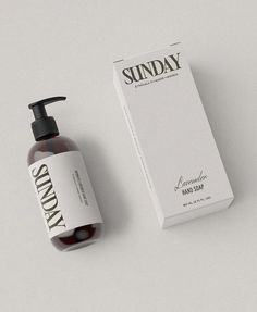 a bottle of sunday hand soap next to a box on a white table top