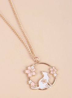 a necklace with a cat and flowers on it