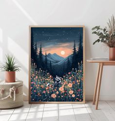 an art print on the wall next to a potted plant and vase with flowers