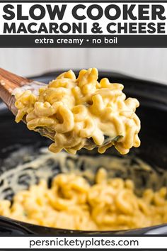 slow cooker macaroni and cheese in a crock pot with a wooden spoon